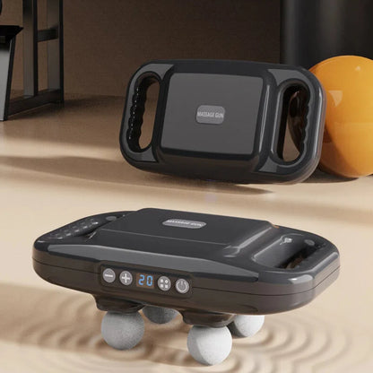 Black handheld massage device with digital display on a beige surface, with an orange ball in the background.